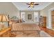 Comfortable bedroom with hardwood floors, ceiling fan, windows with blinds, and a decorative dresser at 9243 Marina Pkwy., Myrtle Beach, SC 29572