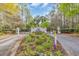 Welcoming entrance to Bal Harbor with lush landscaping, mature trees, and a secure gated entry at 9243 Marina Pkwy., Myrtle Beach, SC 29572