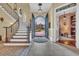 Grand foyer with staircase, chandelier, and arched doorway offering a view of the outdoors at 9243 Marina Pkwy., Myrtle Beach, SC 29572