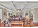 Spacious living room featuring coffered ceilings, hardwood floors, and comfortable leather seating arrangement at 9243 Marina Pkwy., Myrtle Beach, SC 29572