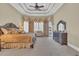 Luxurious Primary bedroom suite with a tray ceiling, plush carpeting, and ample natural light at 9243 Marina Pkwy., Myrtle Beach, SC 29572
