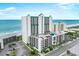 Expansive aerial view of oceanfront condo building with parking garage and stunning ocean views at 102 N Ocean Blvd. # 903, North Myrtle Beach, SC 29582