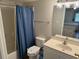 Bathroom with blue shower curtain and single sink vanity at 102 N Ocean Blvd. # 903, North Myrtle Beach, SC 29582