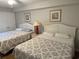 Bedroom features two queen beds, ceiling fan and nautical decor at 102 N Ocean Blvd. # 903, North Myrtle Beach, SC 29582