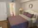 Bedroom with queen bed next to open ensuite bathroom at 102 N Ocean Blvd. # 903, North Myrtle Beach, SC 29582