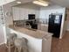 Bright kitchen with white cabinetry, breakfast bar, and modern black appliances at 102 N Ocean Blvd. # 903, North Myrtle Beach, SC 29582