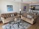 Spacious living room with comfortable sofas, an area rug, and open access to the dining and kitchen area at 102 N Ocean Blvd. # 903, North Myrtle Beach, SC 29582