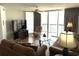 Comfortable living room with a ceiling fan and large glass doors to the balcony with an ocean view at 102 N Ocean Blvd. # 903, North Myrtle Beach, SC 29582