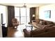 Cozy living room with plush seating, hardwood floors, and ocean view through sliding glass doors at 102 N Ocean Blvd. # 903, North Myrtle Beach, SC 29582