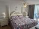 Serene bedroom with a four-poster bed, ocean decor, and private access to a balcony at 102 N Ocean Blvd. # 903, North Myrtle Beach, SC 29582