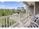 Balcony featuring white Adirondack chairs with striped pillows and neighborhood views at 1101 Bronwyn Circle, North Myrtle Beach, SC 29582