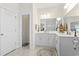 This well-lit bathroom boasts double sinks, a large mirror, and ample counter space, perfect for busy mornings at 1101 Bronwyn Circle, North Myrtle Beach, SC 29582