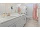 Bathroom featuring double sinks, vanity with white cabinets, and shower-tub combination at 1101 Bronwyn Circle, North Myrtle Beach, SC 29582