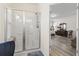 The glass enclosed shower features a built-in bench and is located adjacent to the main bedroom at 1101 Bronwyn Circle, North Myrtle Beach, SC 29582