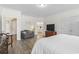 A spacious bedroom with hardwood flooring and natural light offers a cozy sitting area and ensuite bathroom at 1101 Bronwyn Circle, North Myrtle Beach, SC 29582