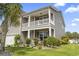 Two-story home with balcony, well-maintained landscaping, and a charming front porch at 1101 Bronwyn Circle, North Myrtle Beach, SC 29582