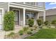 Charming front porch with landscaping, including river rock and various shrubs and plants at 1101 Bronwyn Circle, North Myrtle Beach, SC 29582