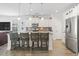 Kitchen island with bar seating, stainless steel appliances, and white cabinets for a modern, functional space at 1101 Bronwyn Circle, North Myrtle Beach, SC 29582