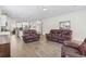 Spacious open-concept living area showcasing leather furniture, wood-look tile flooring, and kitchen view at 1101 Bronwyn Circle, North Myrtle Beach, SC 29582