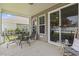 Covered patio featuring an outdoor dining table and seating, with sliding glass door access to the interior at 1101 Bronwyn Circle, North Myrtle Beach, SC 29582