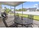 Covered and screened patio features a metal table set for outdoor dining with a view of the fenced yard at 1101 Bronwyn Circle, North Myrtle Beach, SC 29582