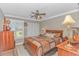 This cozy bedroom boasts a ceiling fan, light-colored wood floors, and plentiful natural light at 111 Hickory Dr., Conway, SC 29526