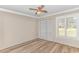 An empty bedroom showcases light walls, wood-look flooring, and natural light at 111 Hickory Dr., Conway, SC 29526