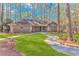 A well-manicured lawn and walkway lead to this brick home surrounded by mature trees at 111 Hickory Dr., Conway, SC 29526