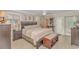 This primary bedroom features neutral decor, a ceiling fan, and sliding glass door access to the outside at 111 Hickory Dr., Conway, SC 29526