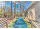 Outdoor shuffleboard court with numbered zones, alongside a covered pavilion and picnic tables in a wooded area at 111 Hickory Dr., Conway, SC 29526