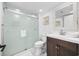 Bathroom with sleek glass enclosed shower and dark wood vanity with decorative mirror at 12 Spartina Ct. # 2, Pawleys Island, SC 29585