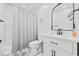Bathroom with shower-tub combo, white vanity with black hardware, and decorative mirror at 12 Spartina Ct. # 2, Pawleys Island, SC 29585