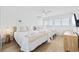 Bright bedroom features two beds, plank floors, neutral color palette, and serene decor at 12 Spartina Ct. # 2, Pawleys Island, SC 29585