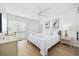Bright bedroom features a ceiling fan, a large bed, and a window at 12 Spartina Ct. # 2, Pawleys Island, SC 29585