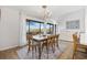 Bright dining area features a wooden table, chandelier, and large windows overlooking the scenic outdoors at 12 Spartina Ct. # 2, Pawleys Island, SC 29585