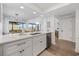 Open concept kitchen features white countertops, stainless steel appliances, and a view into the dining area at 12 Spartina Ct. # 2, Pawleys Island, SC 29585
