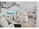Bright, open living room with tall ceilings, modern decor, and seamlessly connects to the dining area at 12 Spartina Ct. # 2, Pawleys Island, SC 29585