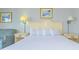 Cozy bedroom featuring a queen bed, vintage lamps, and nautical decor at 1207 S Ocean Blvd. S # 507013, Myrtle Beach, SC 29577