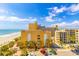 Exterior view of building and landscaping, including a parking lot and sandy beach at 1207 S Ocean Blvd. S # 507013, Myrtle Beach, SC 29577