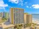 An exterior view of the multi-story building featuring ocean views and many balconies at 1207 S Ocean Blvd. S # 507013, Myrtle Beach, SC 29577