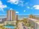 Daytime view of condominiums by the beach with multiple palm trees, parking, and outdoor pools at 1207 S Ocean Blvd. S # 507013, Myrtle Beach, SC 29577