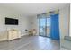 Open living room with hardwood floors and a large sliding glass door to a private balcony at 1207 S Ocean Blvd. S # 507013, Myrtle Beach, SC 29577