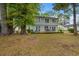 Charming home featuring a wooden deck perfect for outdoor dining and relaxing with lush landscaping at 1213 Oak St., Conway, SC 29526