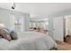 Comfortable bedroom showing access to the bathroom and connecting living room, illuminated by natural light at 1213 Oak St., Conway, SC 29526
