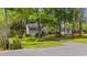 A charming two-story home surrounded by mature trees and colorful flowers, offering great curb appeal at 1213 Oak St., Conway, SC 29526