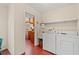 Functional laundry room featuring a washer, dryer, sink, and access to kitchen at 1213 Oak St., Conway, SC 29526