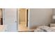 Inviting bedroom shows an ensuite bathroom with a tiled shower and floors just off the main bedroom at 1415 Gooseneck Place # 102, Murrells Inlet, SC 29576