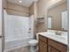 Bathroom with a tub-shower combination, a wooden vanity, and an earth tone paint at 1501 Palmina Loop # B, Myrtle Beach, SC 29588