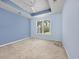 Light-filled bedroom with blue walls, neutral carpet, and a large window offering scenic views at 1501 Palmina Loop # B, Myrtle Beach, SC 29588