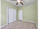 A bedroom painted light green with neutral carpet flooring and has two white paneled doors at 1501 Palmina Loop # B, Myrtle Beach, SC 29588